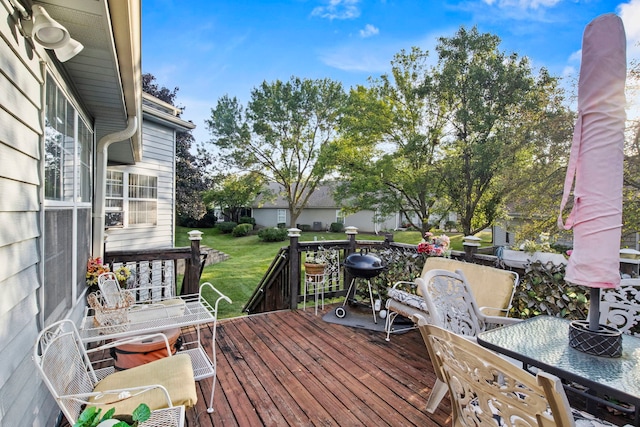 deck with a yard and outdoor dining area