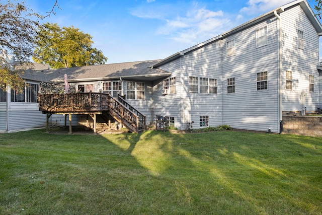 rear view of property featuring stairway, a lawn, and a wooden deck