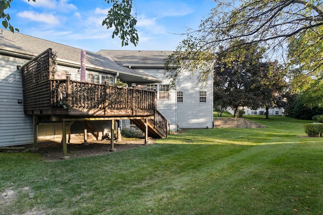 back of property featuring a lawn, a wooden deck, and stairs