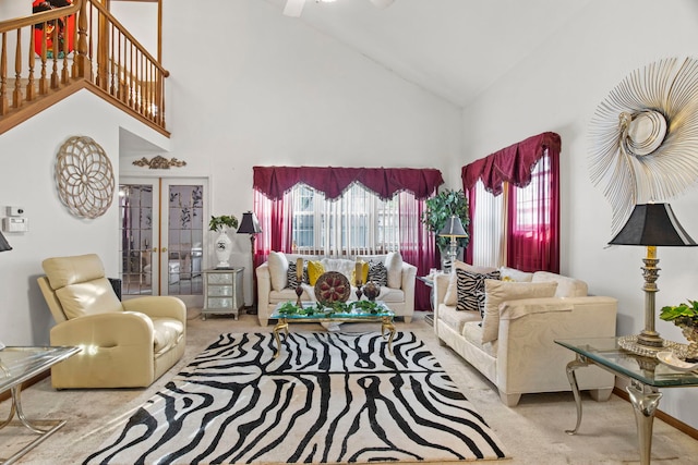 carpeted living room featuring french doors and high vaulted ceiling