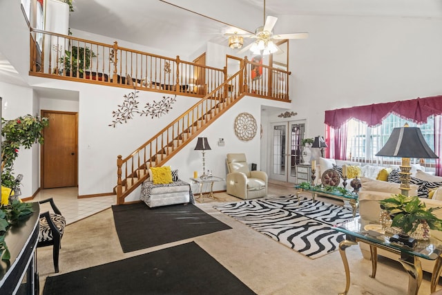 carpeted living room featuring baseboards, stairs, french doors, a towering ceiling, and tile patterned floors