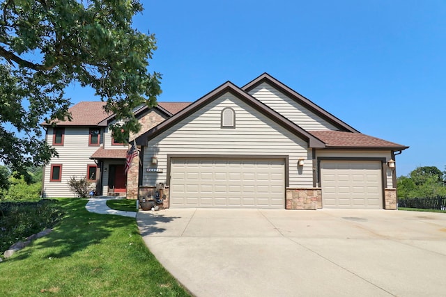 view of front of house featuring a garage and a front lawn