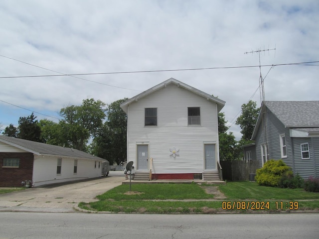 view of front facade with entry steps and a front lawn