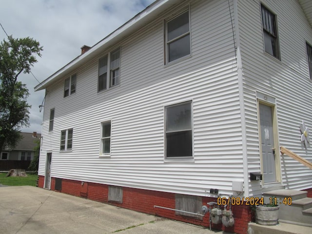 view of side of home with a patio area