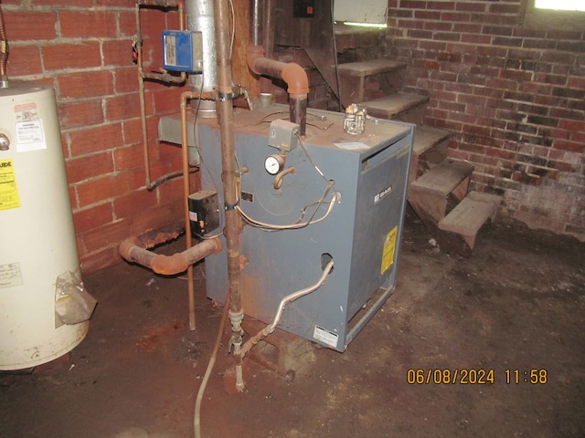 utility room featuring heating unit and water heater