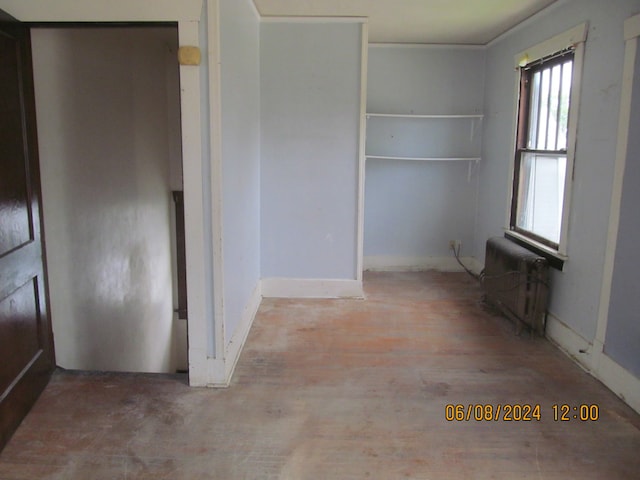 interior space featuring radiator heating unit and hardwood / wood-style floors