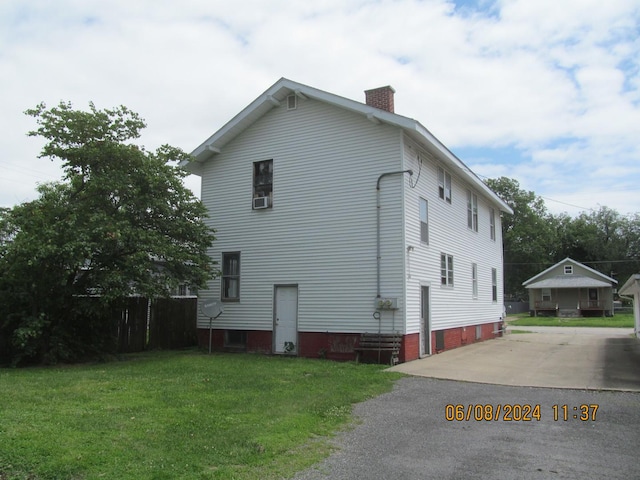 view of property exterior featuring a chimney and a yard