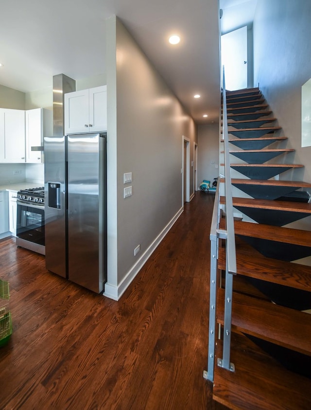 interior space featuring white cabinets, dark hardwood / wood-style floors, and stainless steel appliances