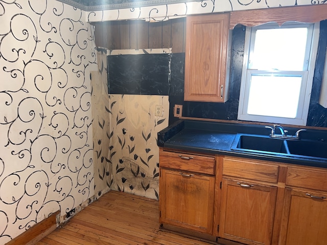 kitchen featuring light wood-type flooring and sink