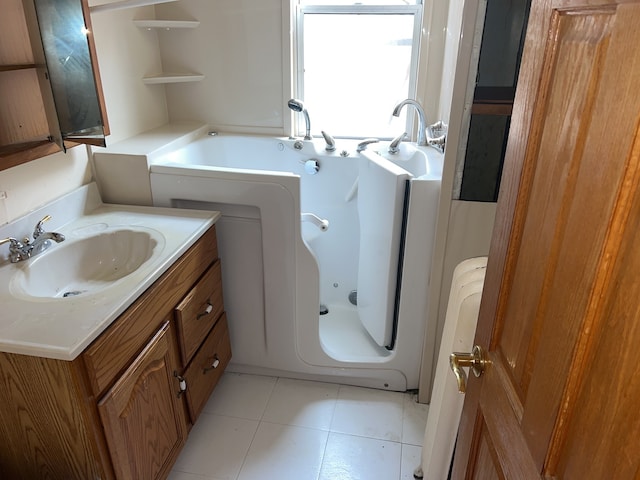 bathroom featuring tile patterned flooring, vanity, and a bathtub