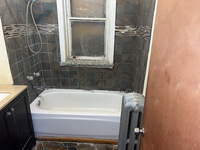 bathroom with vanity and tiled shower / bath