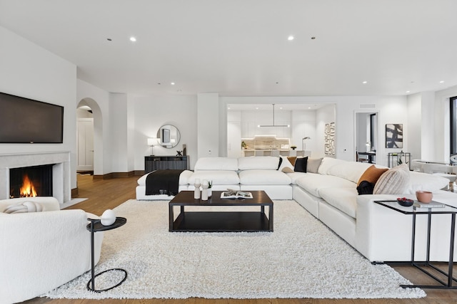 21 N May St Unit 402, Chicago, IL 60607 - living room with arched walkways, wood finished floors, a fireplace with flush hearth, and recessed lighting