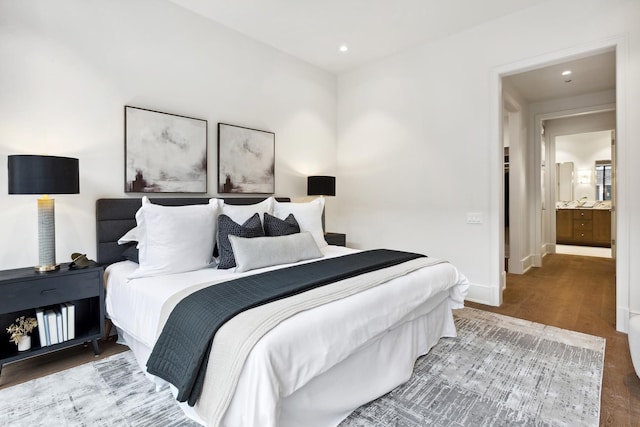 bedroom with recessed lighting, wood finished floors, and baseboards