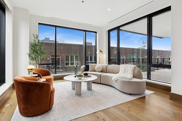 21 N May St Unit 402, Chicago, IL 60607 - living area featuring healthy amount of natural light, wood finished floors, floor to ceiling windows, and recessed lighting