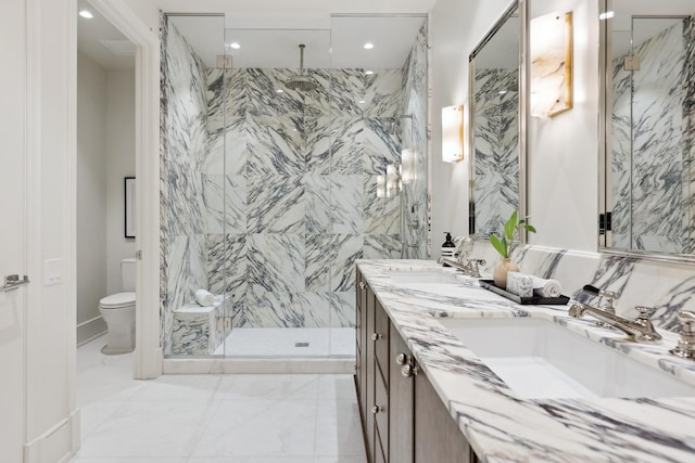 bathroom with marble finish floor, a marble finish shower, double vanity, toilet, and a sink