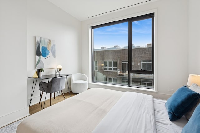 21 N May St Unit 402, Chicago, IL 60607 - bedroom with vaulted ceiling, baseboards, and wood finished floors