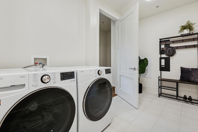 21 N May St Unit 402, Chicago, IL 60607 - laundry area featuring washer and dryer and light tile patterned flooring
