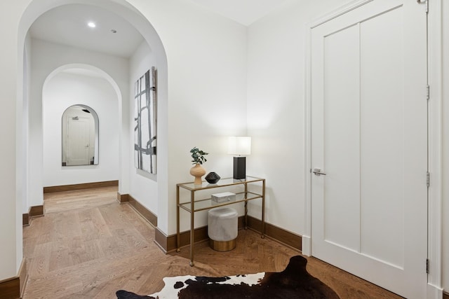 21 N May St Unit 402, Chicago, IL 60607 - corridor featuring baseboards, arched walkways, and wood finished floors
