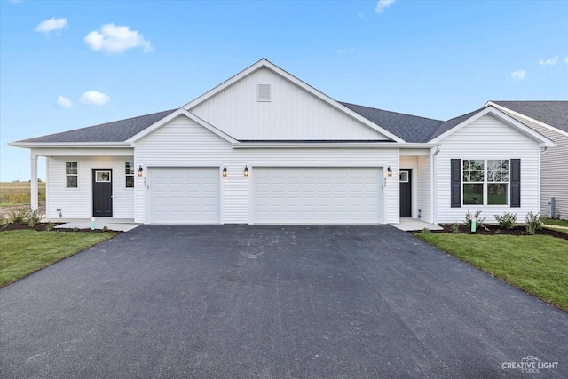 ranch-style home featuring a garage and a front lawn