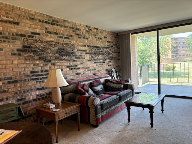 carpeted living room with brick wall