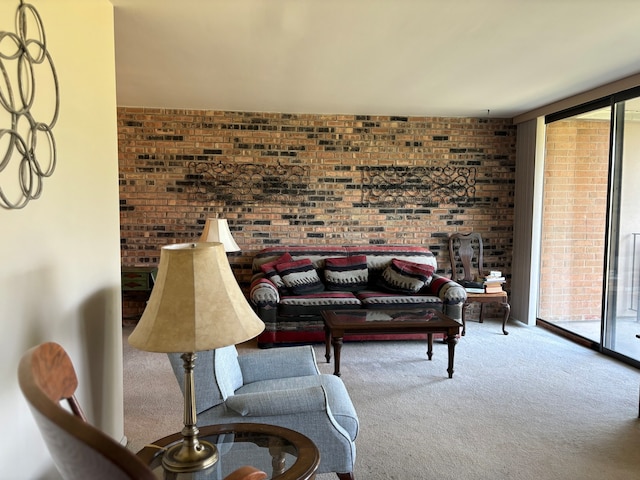 carpeted living room with brick wall and floor to ceiling windows