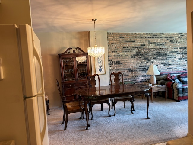 dining space with carpet flooring and a chandelier