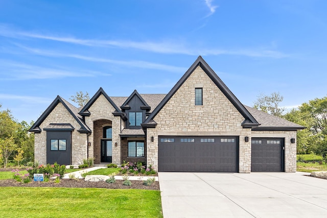 view of front facade with a shingled roof and concrete driveway