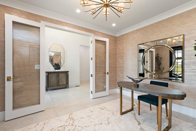 interior space featuring a chandelier, french doors, and crown molding