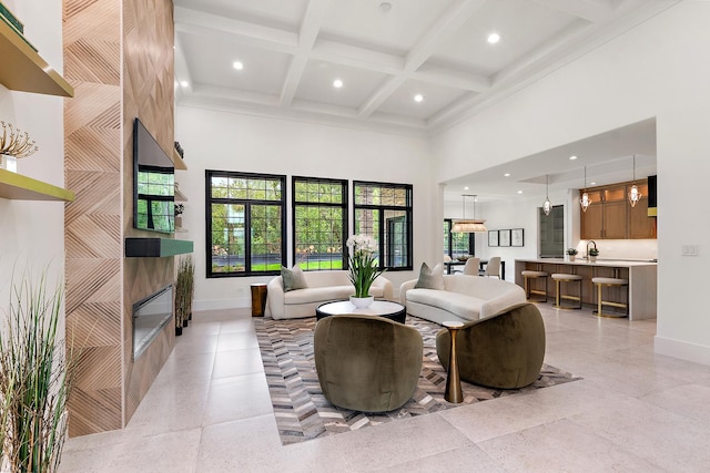 living room featuring beamed ceiling, a towering ceiling, coffered ceiling, and a tiled fireplace