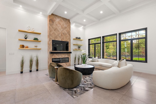 living room with beam ceiling, coffered ceiling, a towering ceiling, and a tiled fireplace