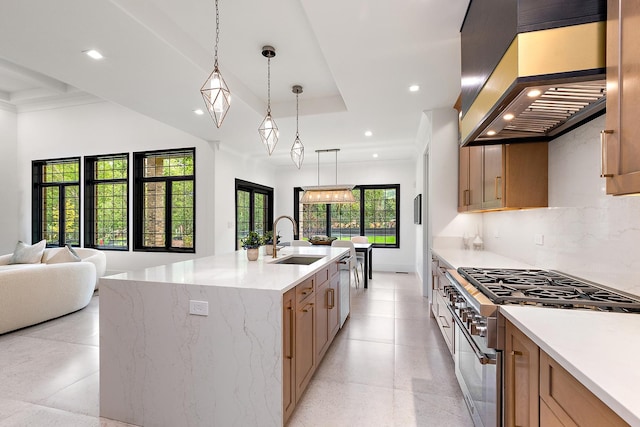 kitchen featuring a sink, stainless steel appliances, wall chimney range hood, backsplash, and recessed lighting