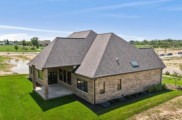 back of house with a yard and a patio area