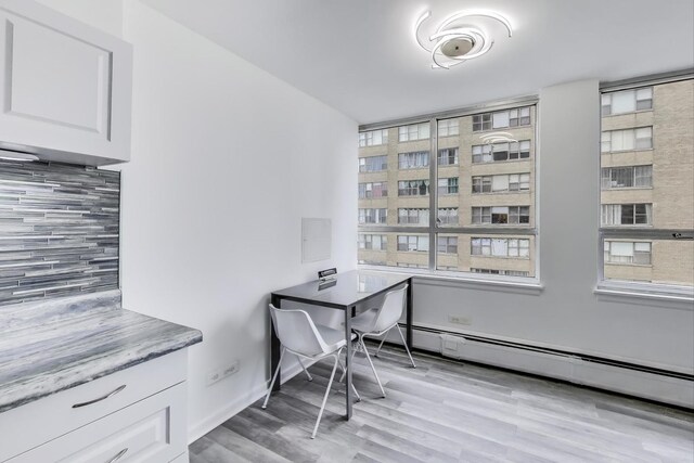 6171 N Sheridan Rd Unit 1508, Chicago, IL 60660 - office space with a baseboard radiator, light wood finished floors, and plenty of natural light