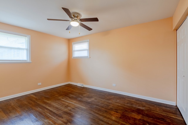 interior space with a closet, ceiling fan, and dark hardwood / wood-style floors