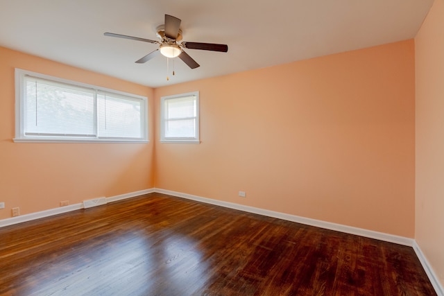 empty room with ceiling fan and hardwood / wood-style flooring