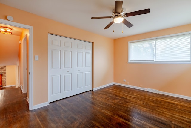 unfurnished bedroom featuring a closet, ceiling fan, and dark hardwood / wood-style flooring