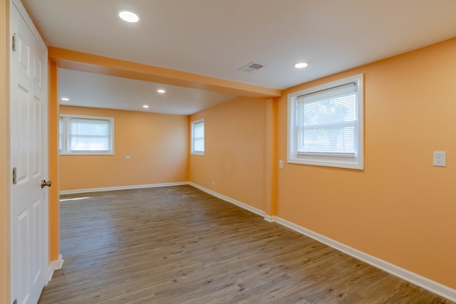 spare room with a healthy amount of sunlight and hardwood / wood-style flooring