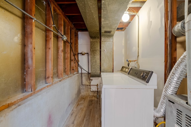 laundry area featuring wood-type flooring and washing machine and clothes dryer