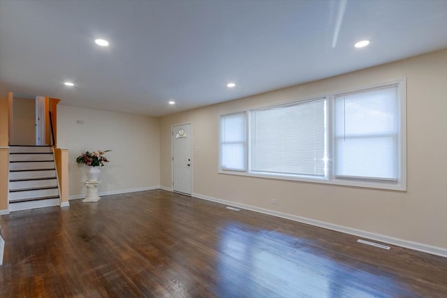 unfurnished living room featuring hardwood / wood-style floors and a wealth of natural light