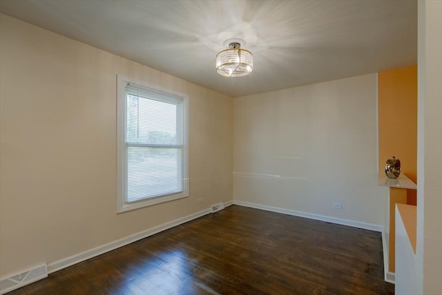 unfurnished room with dark hardwood / wood-style flooring