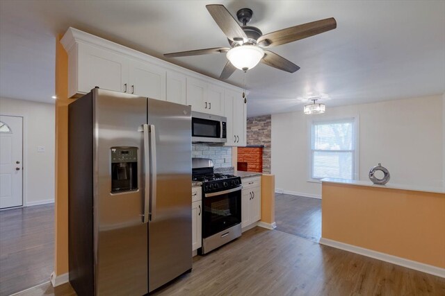 kitchen with light hardwood / wood-style floors, appliances with stainless steel finishes, ceiling fan, and white cabinets