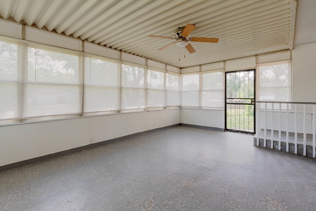 unfurnished sunroom featuring ceiling fan