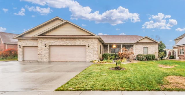 view of front of property with a front yard and a garage