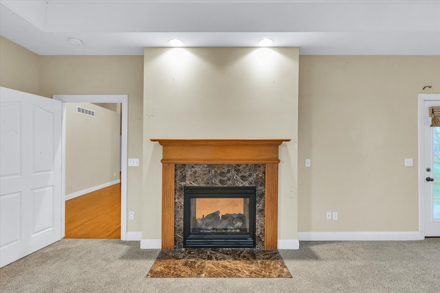 unfurnished living room featuring carpet floors and a premium fireplace