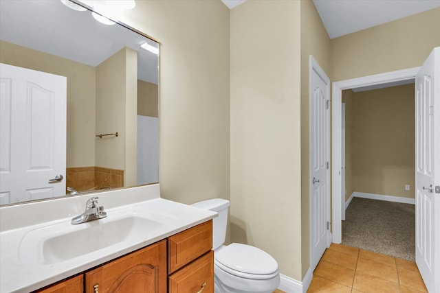 bathroom with tile patterned flooring, vanity, and toilet