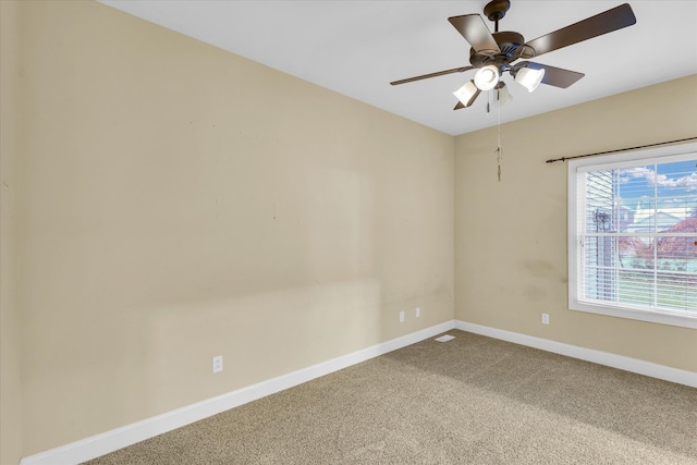 spare room featuring carpet and ceiling fan