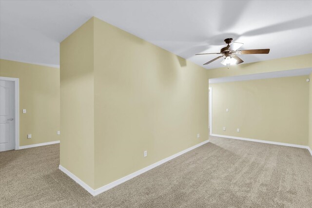 spare room featuring ceiling fan and carpet floors