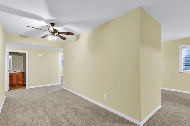 carpeted spare room with ceiling fan