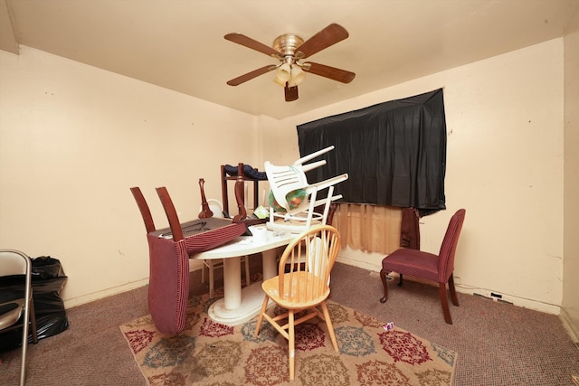 carpeted dining room featuring ceiling fan