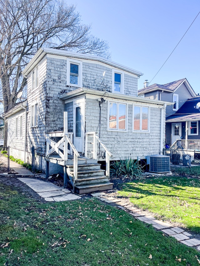 exterior space featuring central AC and a lawn